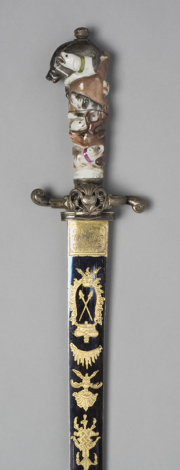 An remarkable German Hunting Hanger with a blued and artfully gilded blade, silver fittings and a porcelain grip. Made in Saxony, ca. 1750. Housed at the Philadelphia Museum of Art.