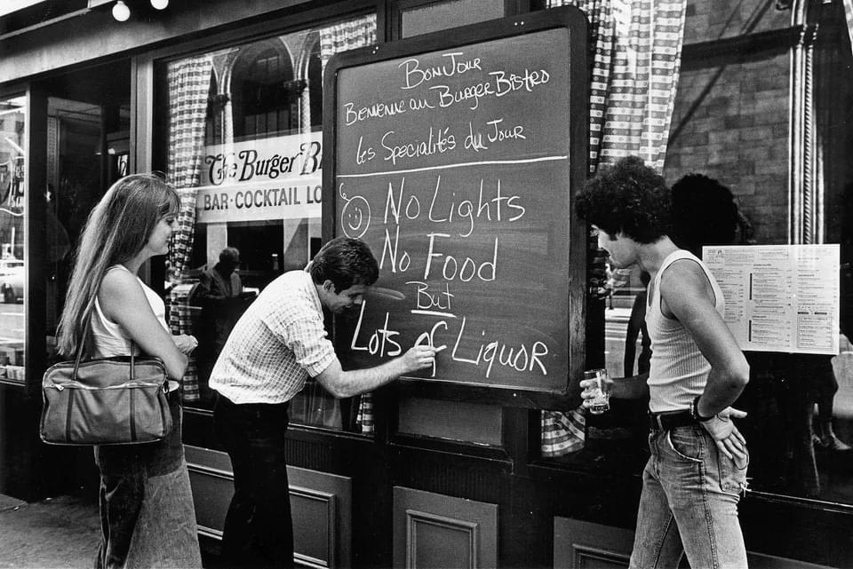 New York Blackout: A restaurant owner writes a sign to advise cutsomers that there is no food and no lights, but lots of liquor after the New York blackout July 13th, 1977 in New York City. Manhattan, 1977 PHOTO: Bryan Alpert
