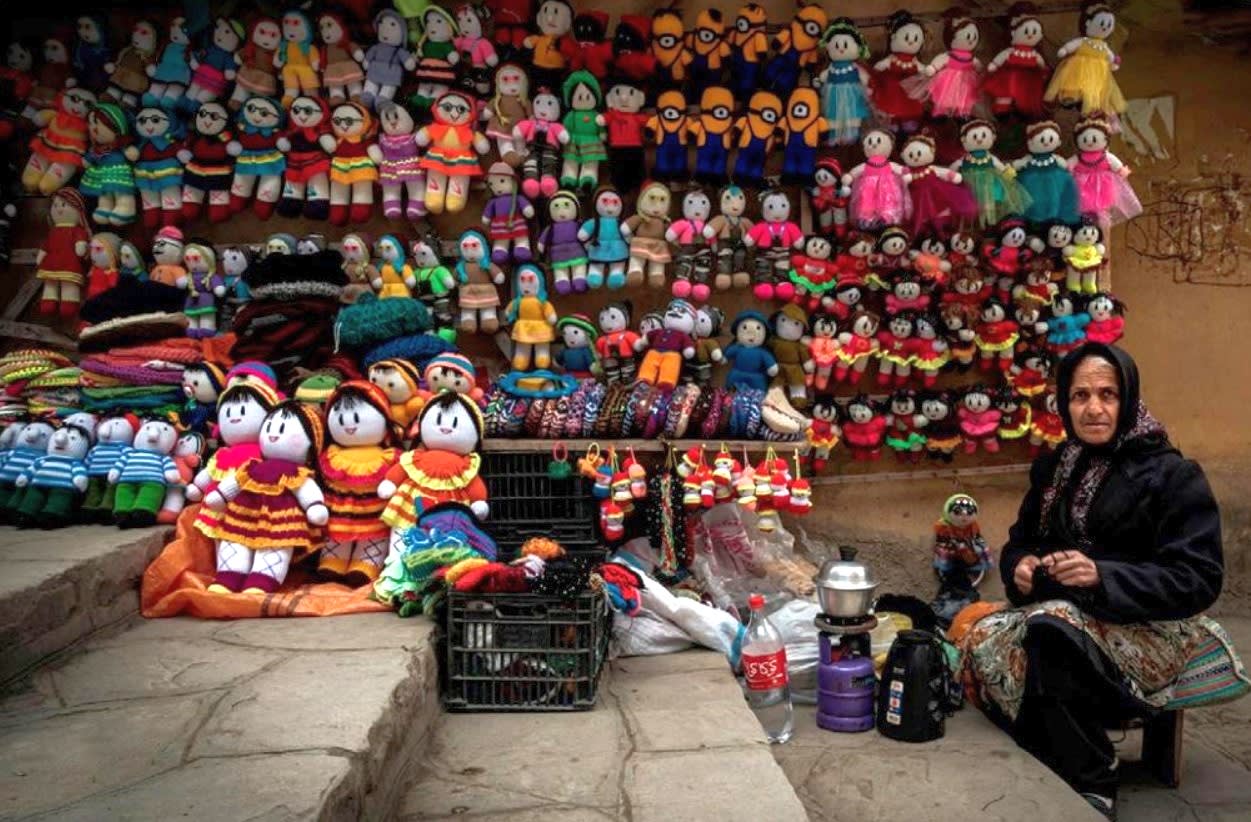 Doll maker selling her wares at market, Iran. (Image - Ali Sabih Kadhim).