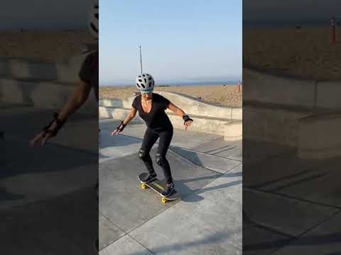 Kid Gives Woman Slight Push to Help Her Slide Down Slope While Skateboarding - 1169869-11