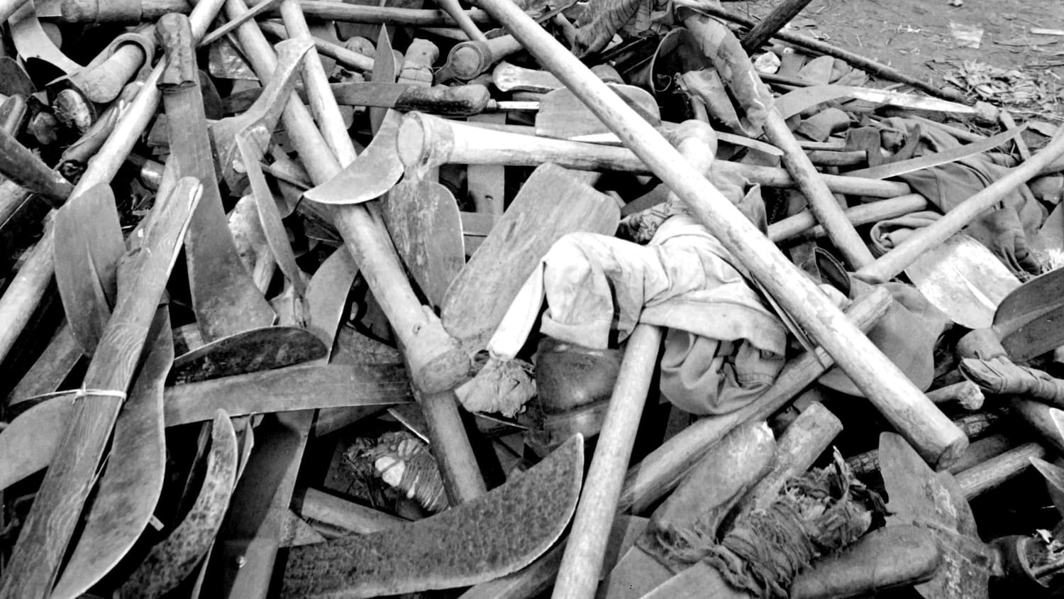 A pile of machetes and hatchets confiscated from Hutu militias who fled Rwanda in the aftermath of the Rwandan Genocide. Goma, Zaire (now Democratic Republic of the Congo), July 1994.