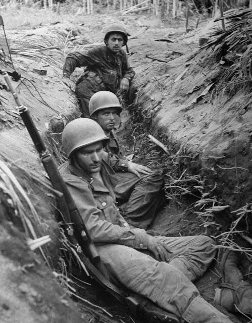 GI's of the 32nd Infantry Division rest in a captured Japanese intercommunication trench, Battle of Buna–Gona