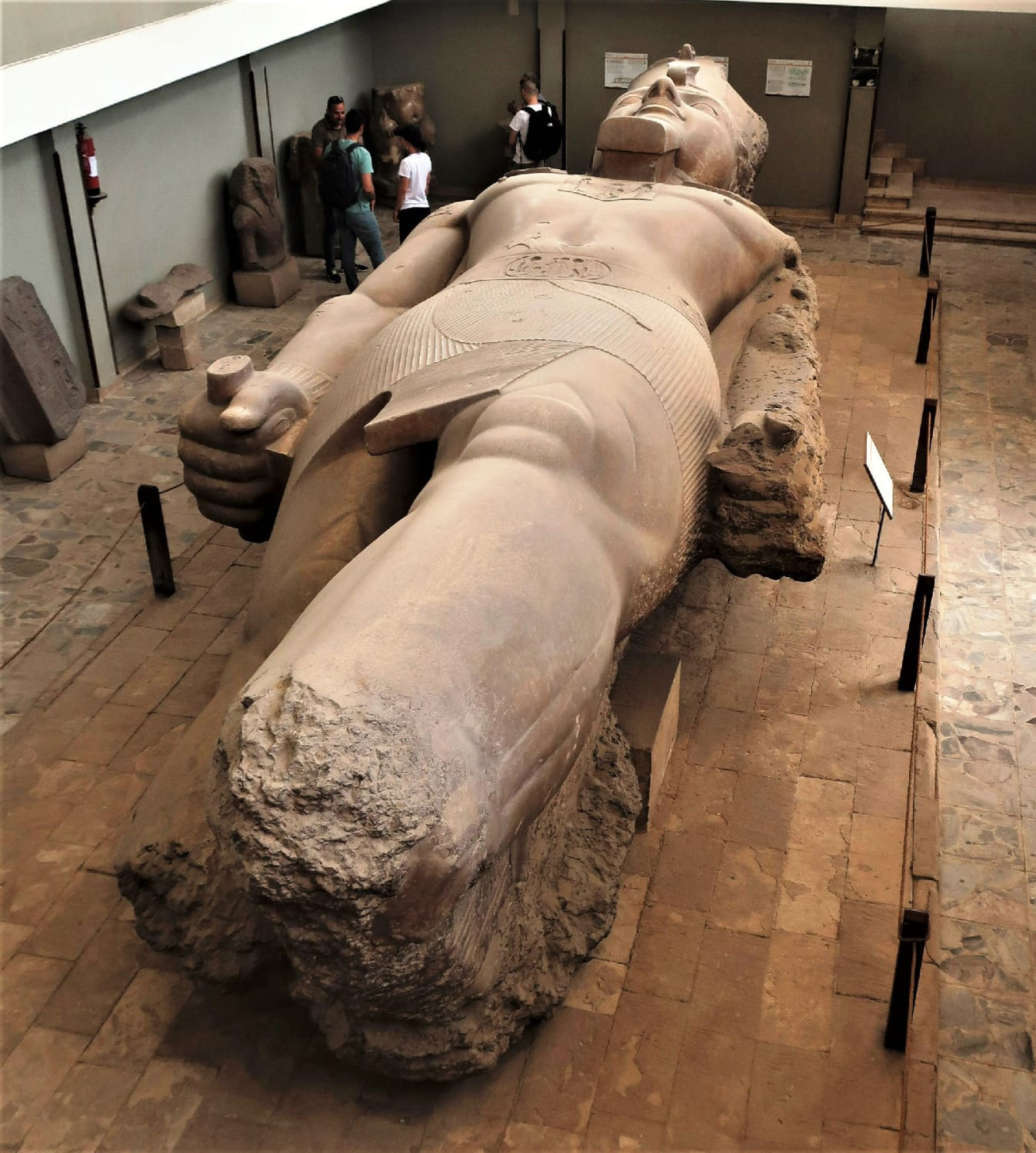 A limestone colossus of King Ramesses II at the Open Air Museum in Memphis (modern-day Mit Rahina), 20 kilometers south of Giza. This statue is about 10 meters long and lying on its back because the base and feet are broken off. Reign: 1279-1213 BC. Photo: Victor Block.