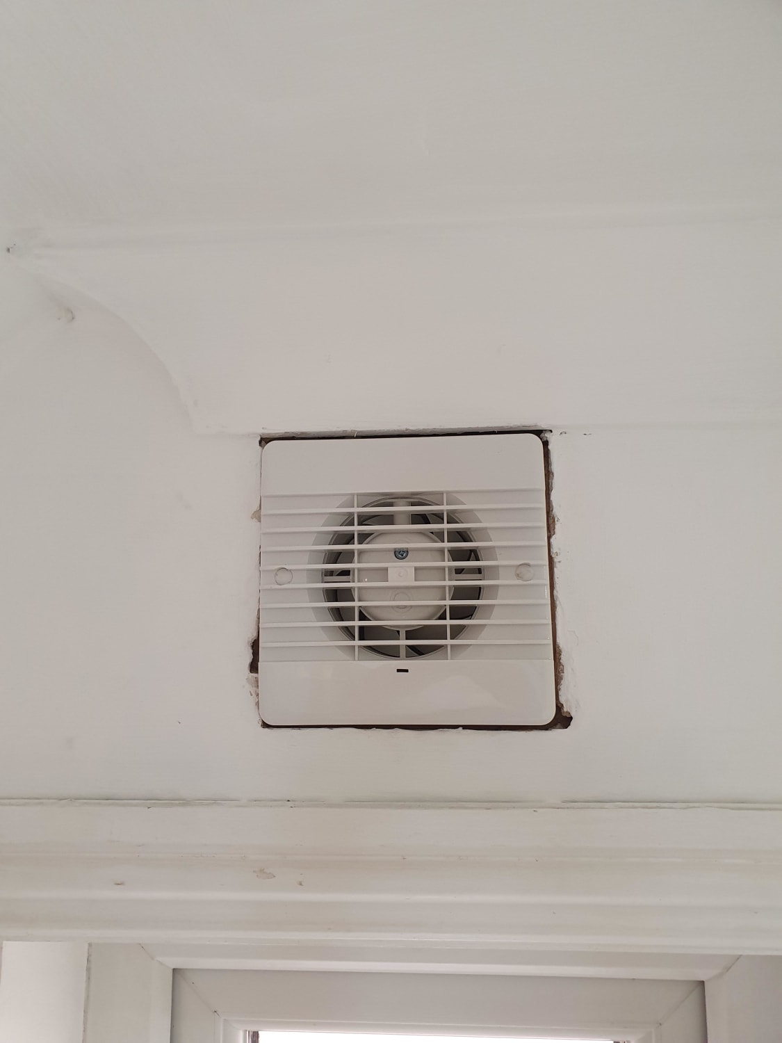 What's the best way to fill around this extractor fan?