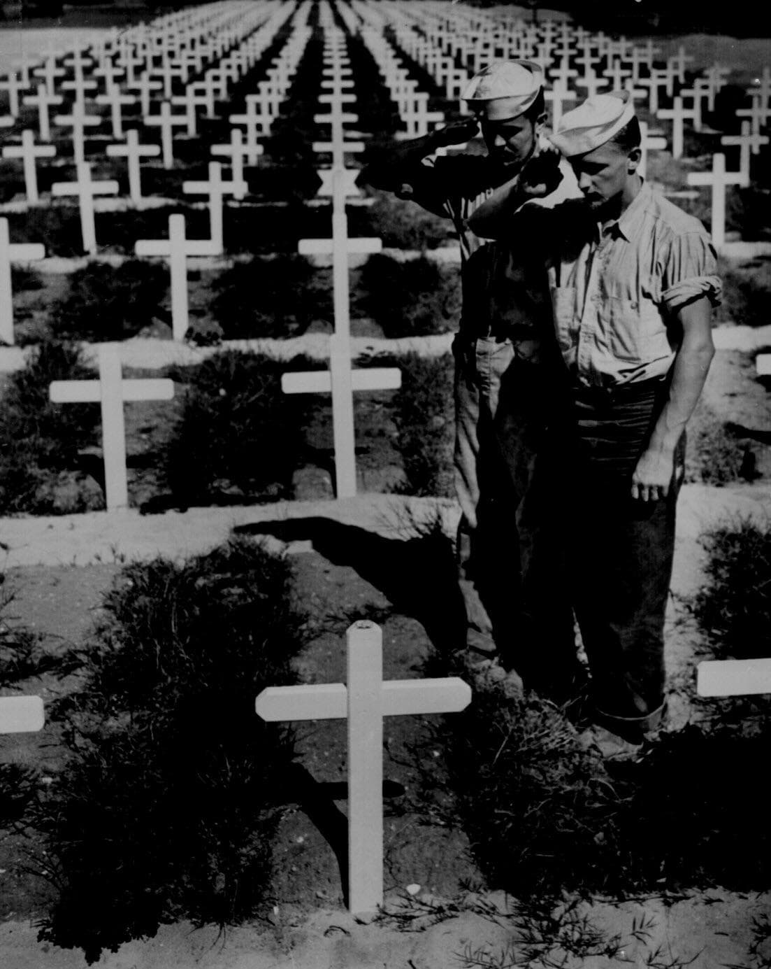 Coast Guardsmen pay silent homage to the memory of a mate who lost his life in action in the Ryukyu Islands, 1945.