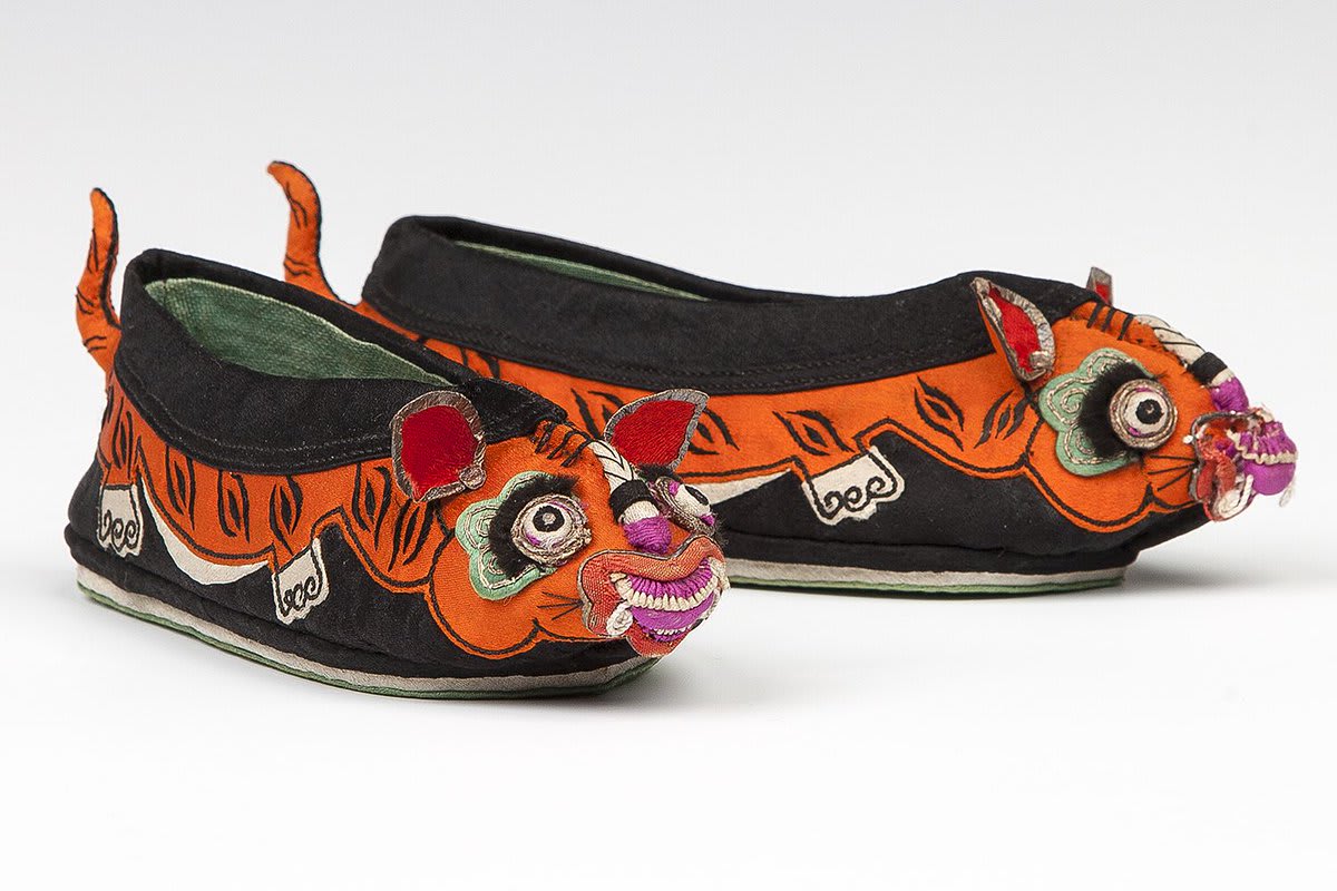For the Lunar New Year in China during the Qing dynasty, sons received a pair of tiger head slippers. Wearing the tiger symbol imbued the child with tiger-like characteristics, helping him grow strong and fearless. Learn more