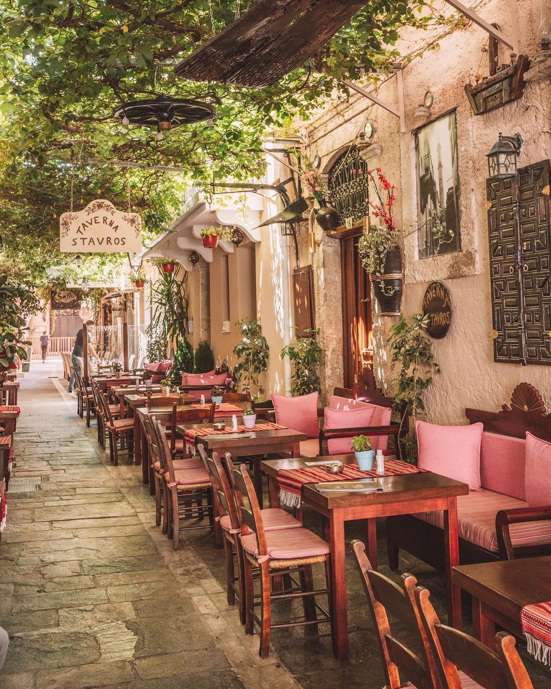 Outdoor dining under a shade in a narrow alley of Rethymno, a small historic city on the island of Crete, Greece.