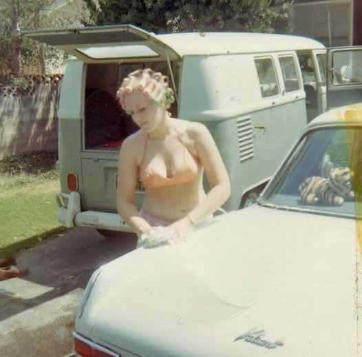 1967. Your grandma, curlers, bikini top, Plymouth Valiant and a VW bus.