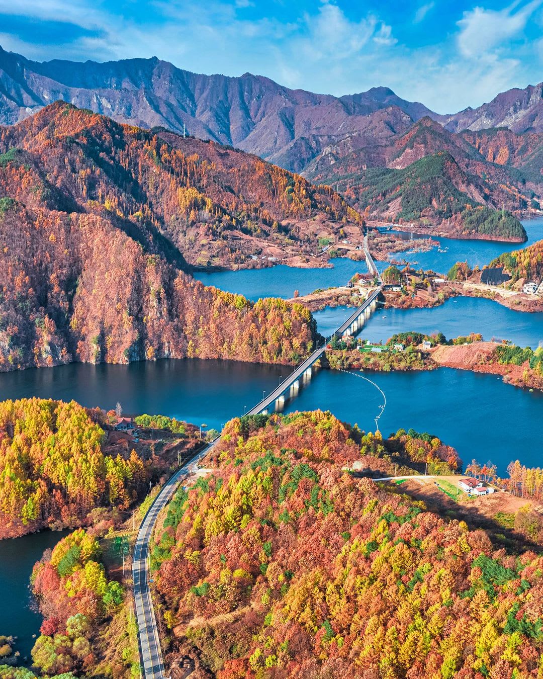 Road passing through the irregular and indented coastline of Yongdam Lake in fall, Jinan County, North Jeolla Province, South Korea.
