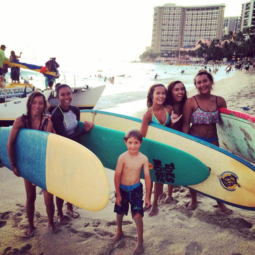 My son hanging with the surfer girls on Waikiki beach Hawaii