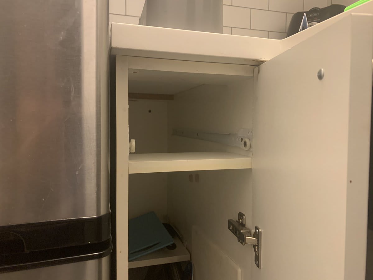 ok handiness twitter, I need your help: my kitchen has no great place to keep silverware. the best is this skinny cabinet, but it can’t open all the way, so the drawer was clearly removed. and there’s only a very short shelf at the top