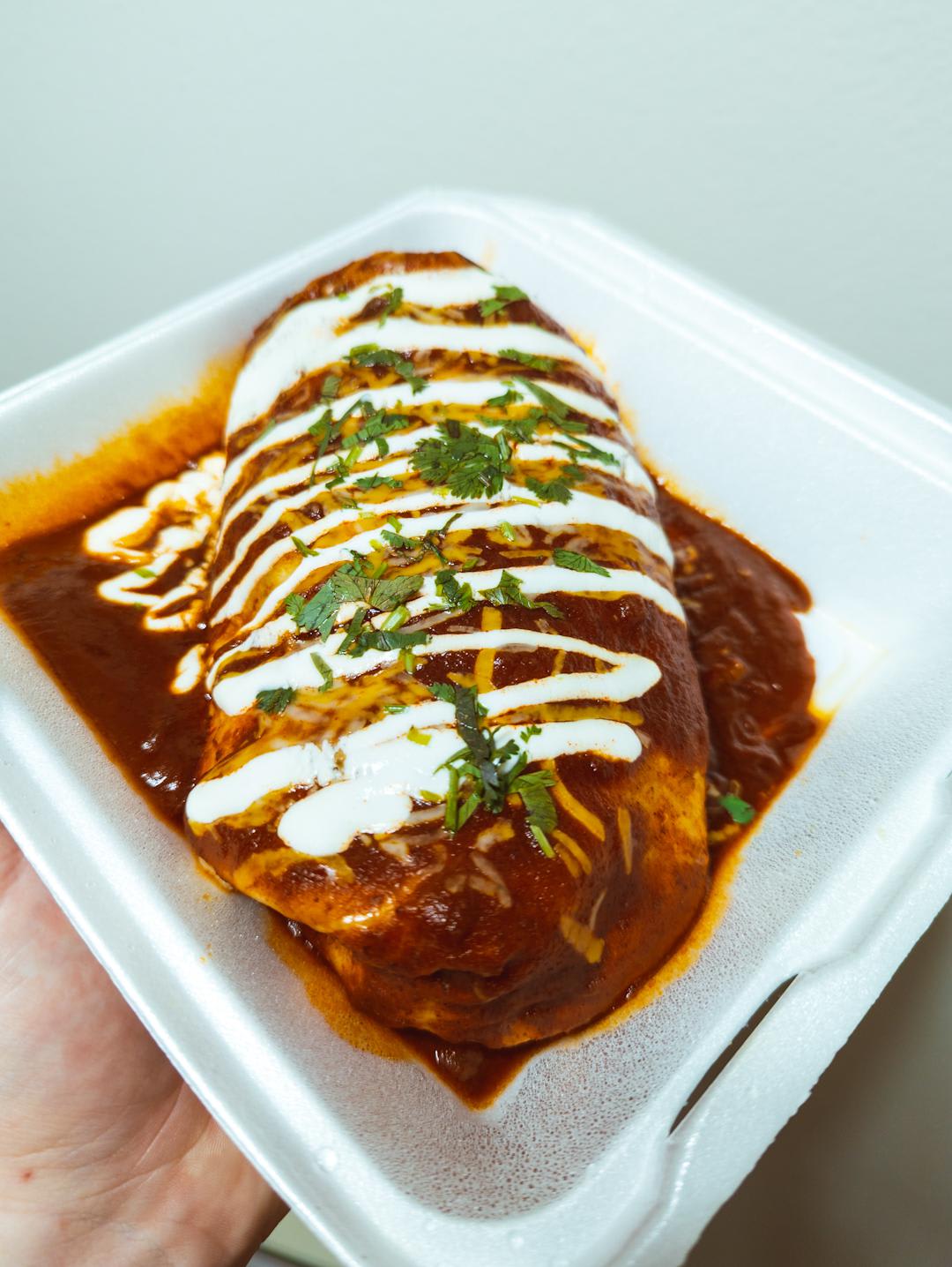 My partner and I split this massive and delicious asada wet burrito we got at a local food truck last night