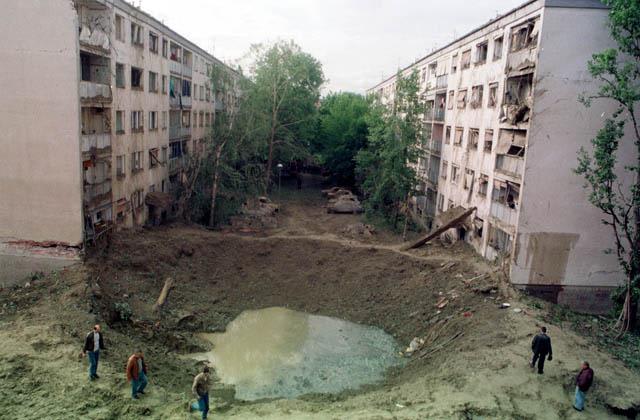 Crater made by NATO missile that struck area between two apartment buildings and elementary school during bombing of Yugoslavia, 1999,