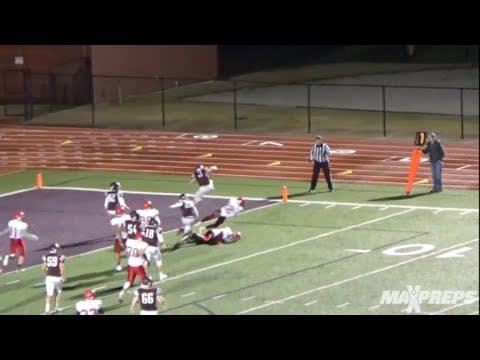 Arkansas recruit Gianni Vannucci hurdles over two defenders for a touchdown
