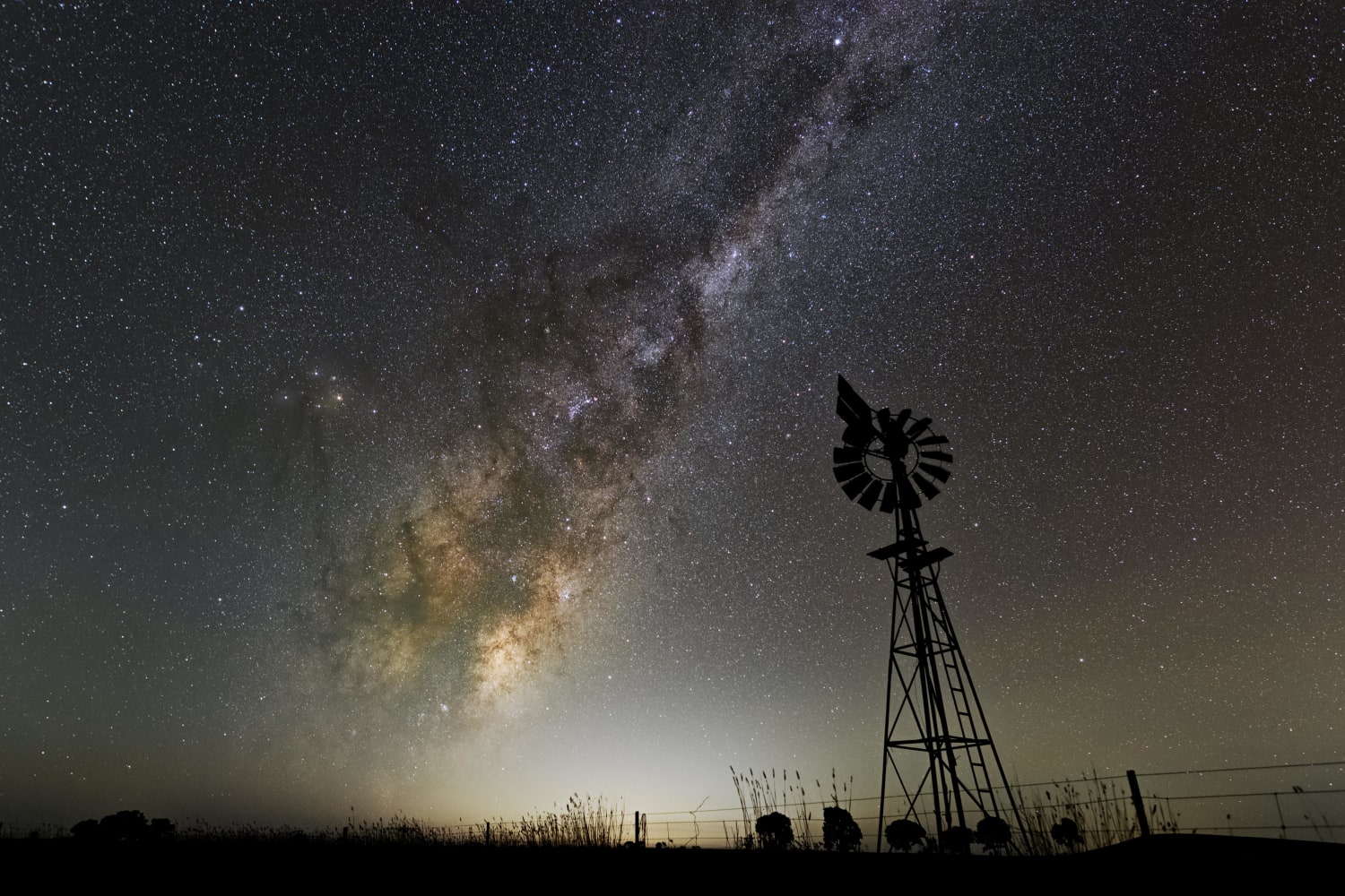 Windmill under a rising Milky Way core.