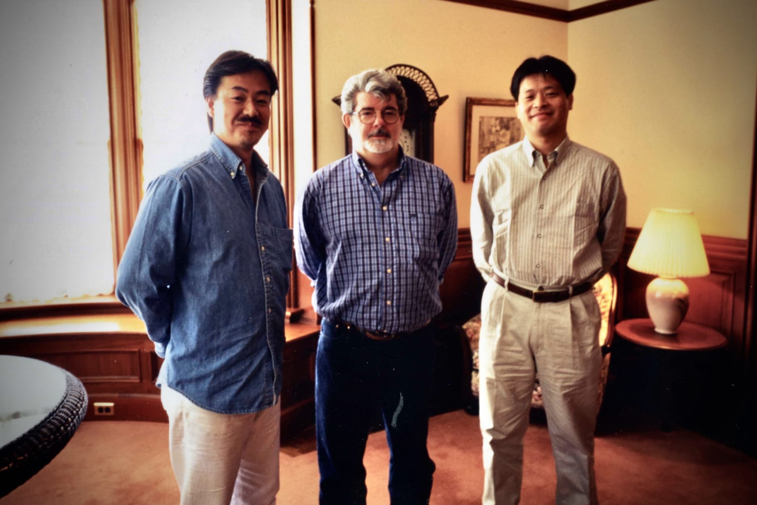 Sakaguchi and Kitase standing with The George Lucas