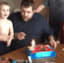 Kid snuffs out his birthday candle with his face.